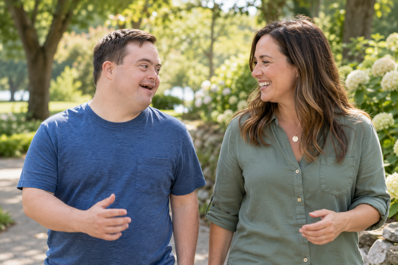 Two adults sharing a cheerful walk in a leafy park